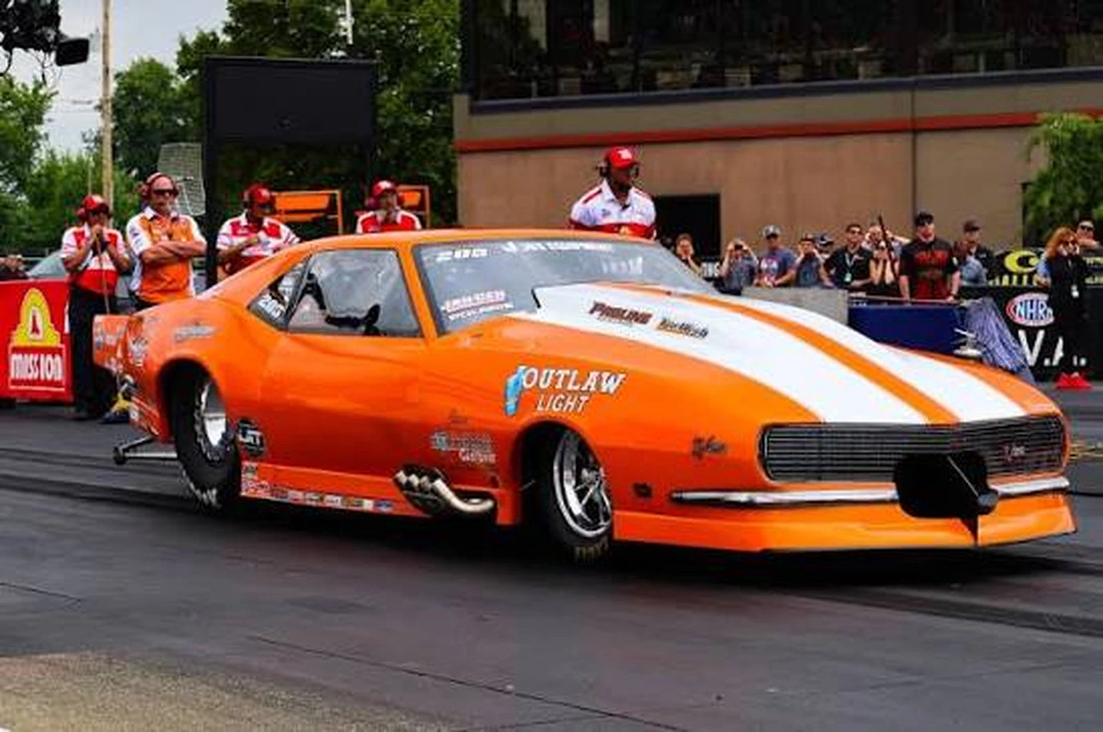Orange drag racing car on track with Mac Fab beadlock wheels